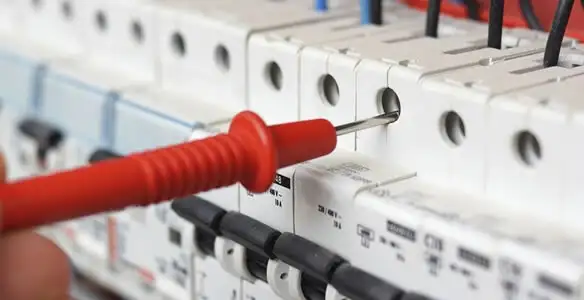 Electrical contractor testing circuit breakers during electrical repair in Shafter, CA