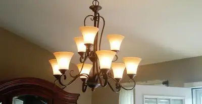 Classic ceiling chandelier installation with warm lighting in Bakersfield, CA