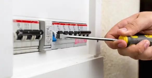 electrical panel upgrade service showing technician adjusting circuit breakers during system upgrade in Bakersfield, CA