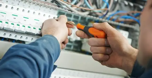 electrical service showing licensed electrician performing electrical panel maintenance and adjustments in Bakersfield, CA