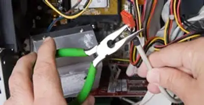Licensed electrical contractor performing electrical repair with tools in Shafter, CA