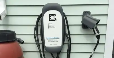 Outdoor electric vehicle charger installation on residential wall in Bakersfield, CA