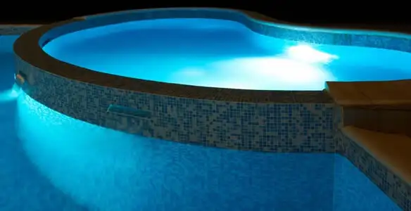 pool light installation and repair services highlighting illuminated pool interior lighting in Bakersfield, CA