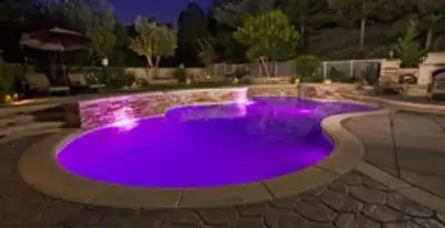 pool light installation and repair services illuminating a residential swimming pool in Bakersfield, CA