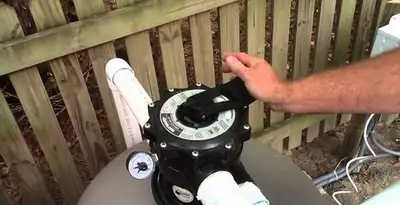 pool pumps service showing professional adjustment of pool pump control system in Bakersfield, CA