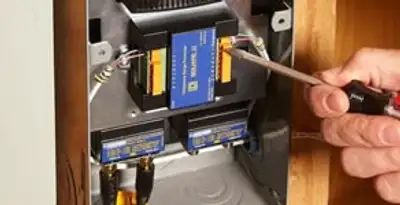 Whole home surge protection device being installed by a licensed electrician to protect electrical systems in Bakersfield, CA